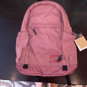 Pink/mauve body with yellow/chartreuse zippers Adjustable straps.